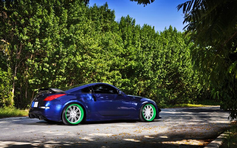 blue sports car with green wheels