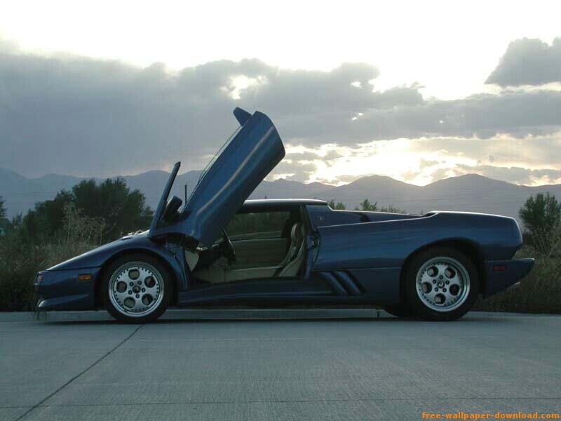 blue sports car with open doors