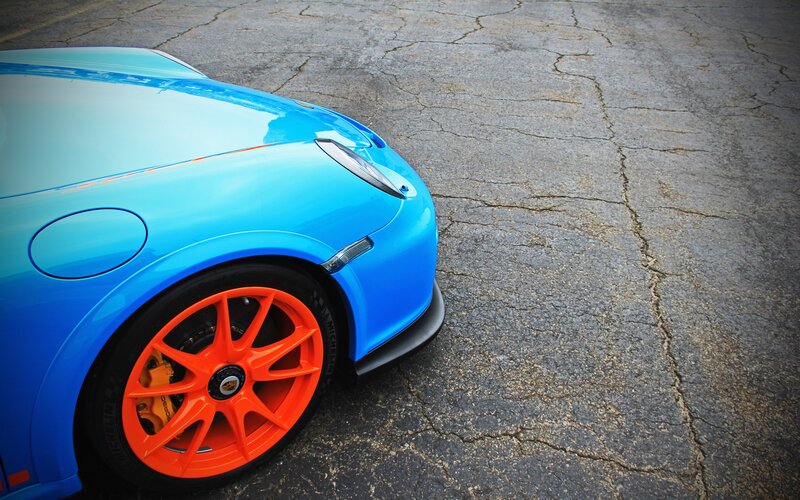 blue sports car with orange wheels