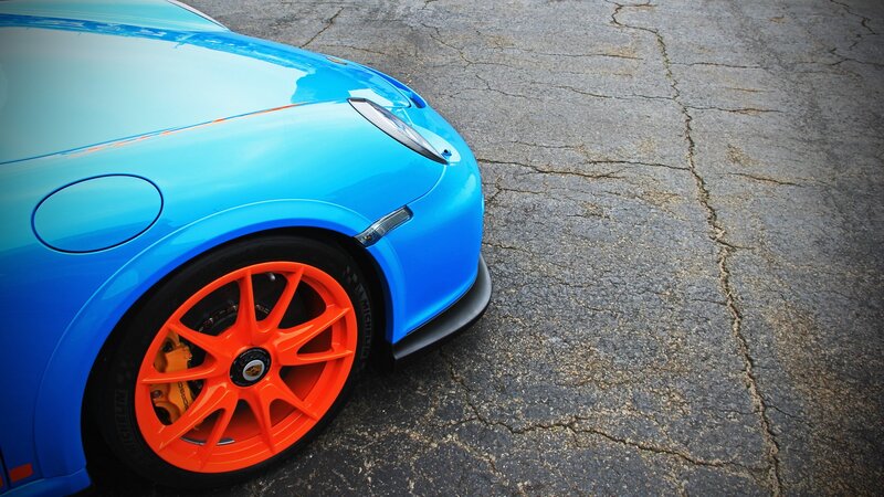 blue sports car with orange wheels