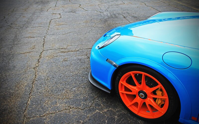 blue sports car with orange wheels