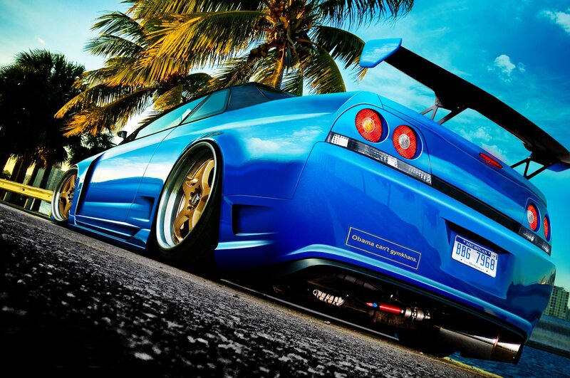 Blue sports car with palm trees