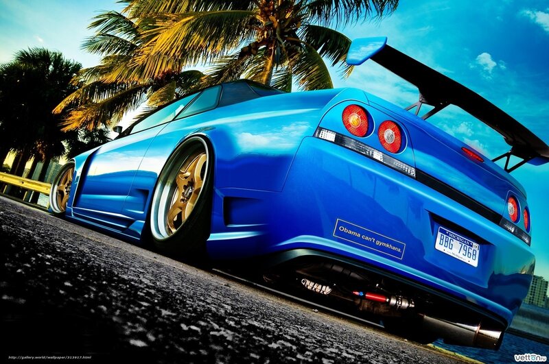 blue sports car with palm trees