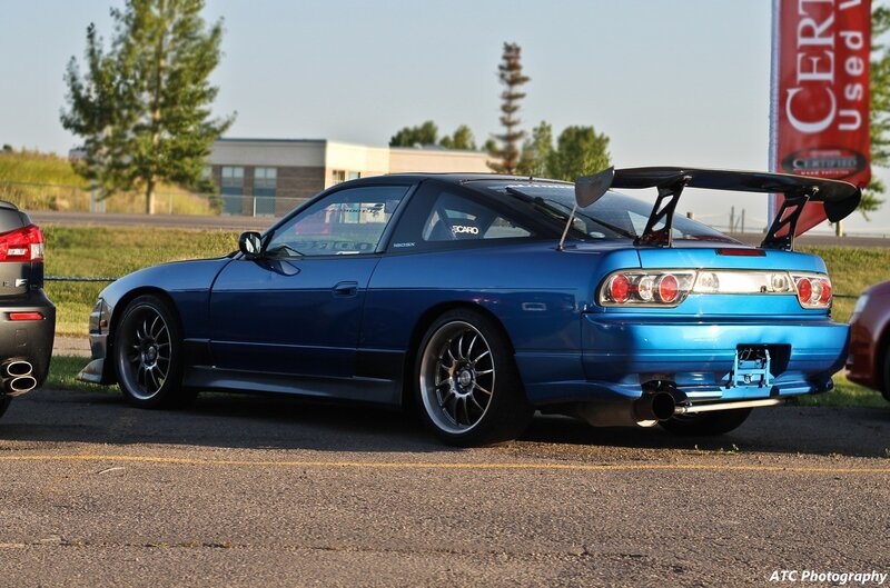 blue sports car with rear wing