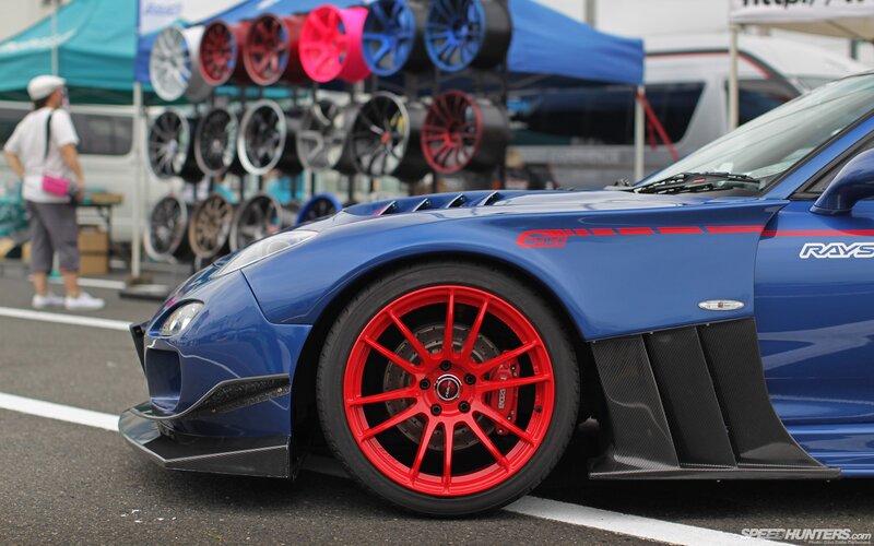 Blue sports car with red wheels