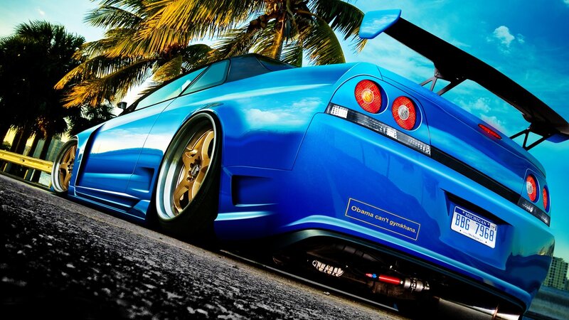 blue sports car with spoiler