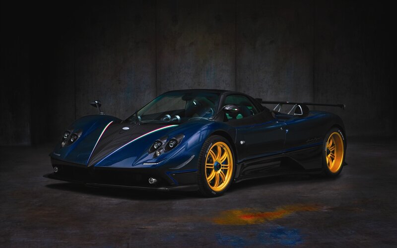 blue sports car with yellow wheels