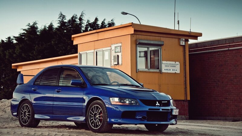Blue Sports Sedan — Dramatic, Sunset