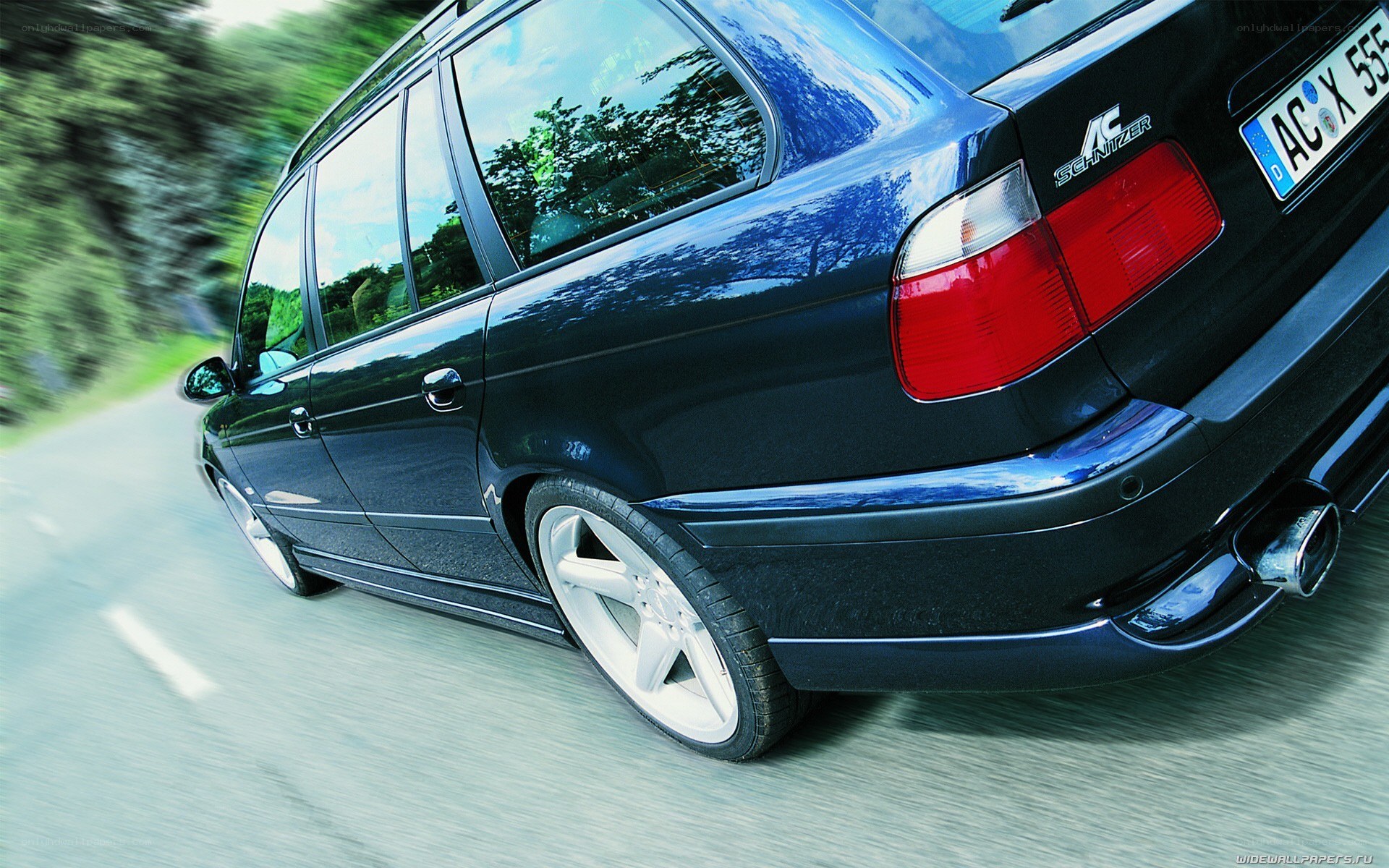 blue station wagon in motion