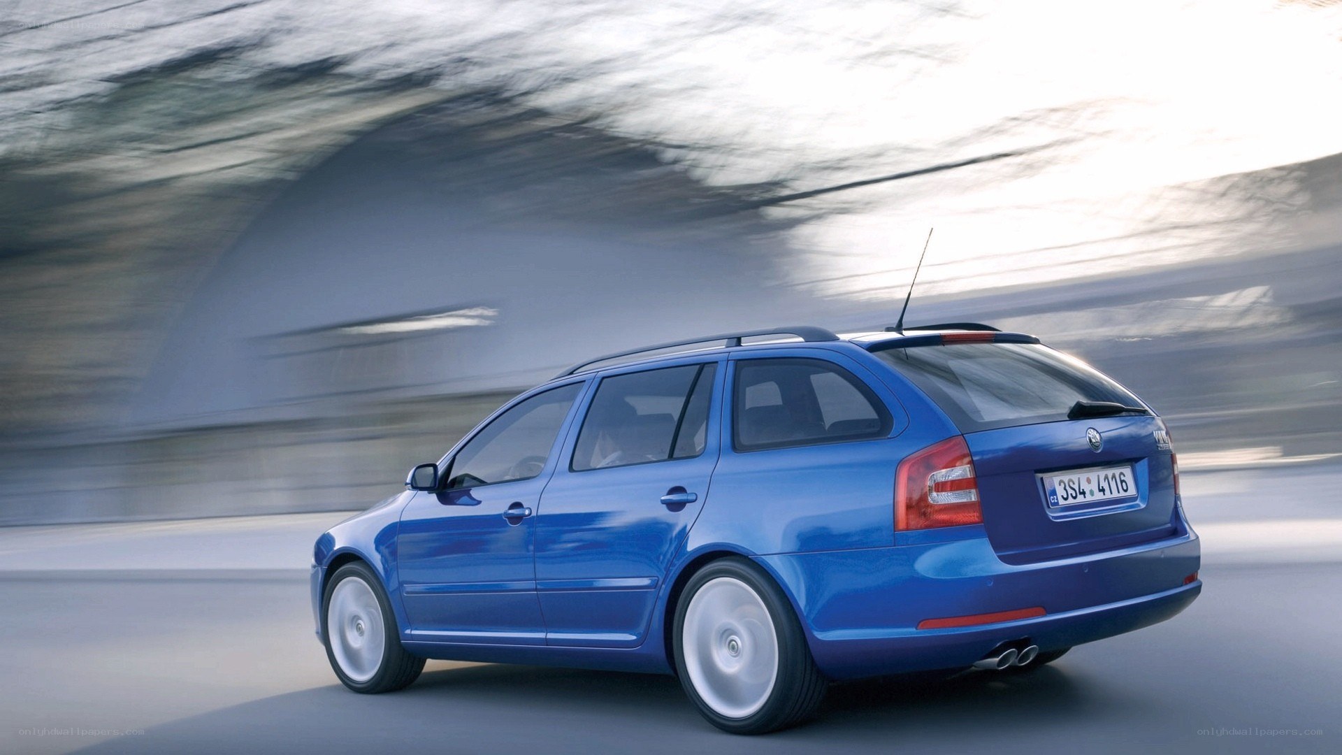 blue station wagon in motion