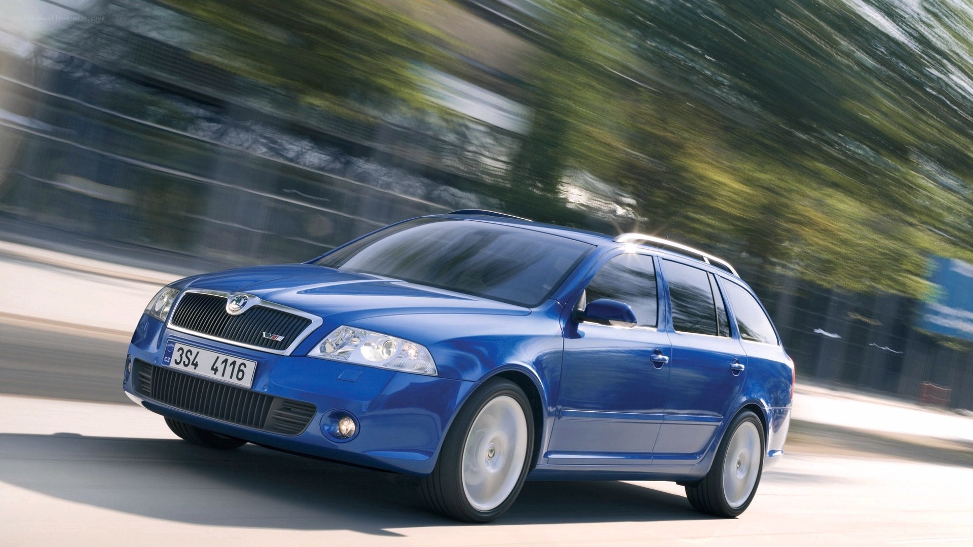 blue station wagon in motion