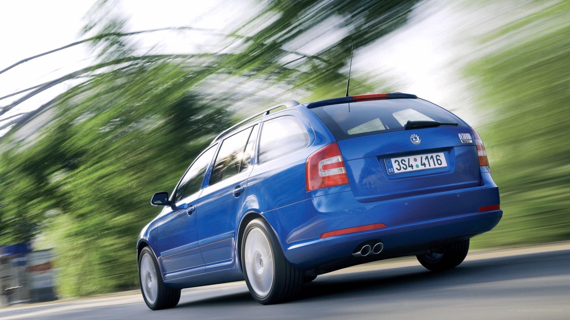 blue station wagon in motion
