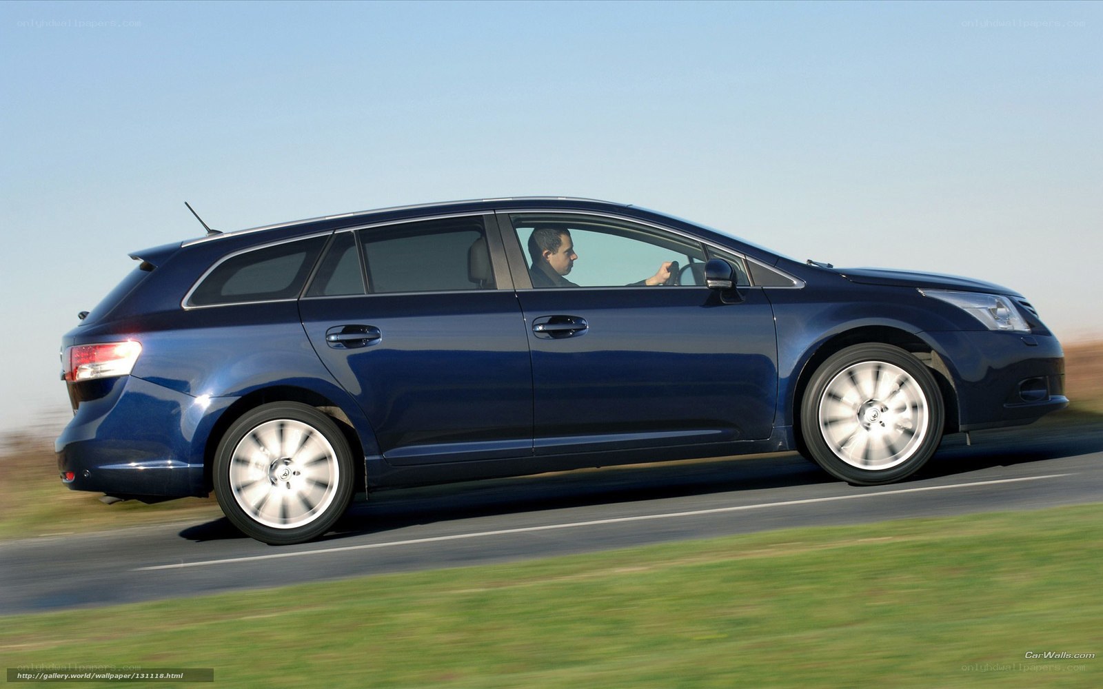 blue station wagon in motion