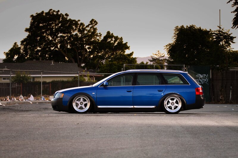 blue station wagon in parking lot