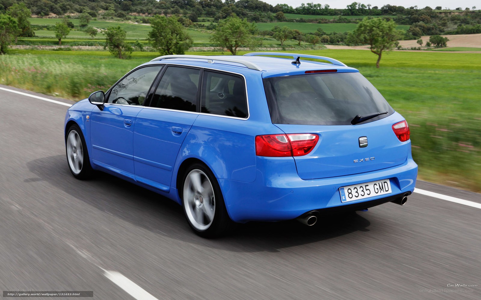 blue station wagon on country road