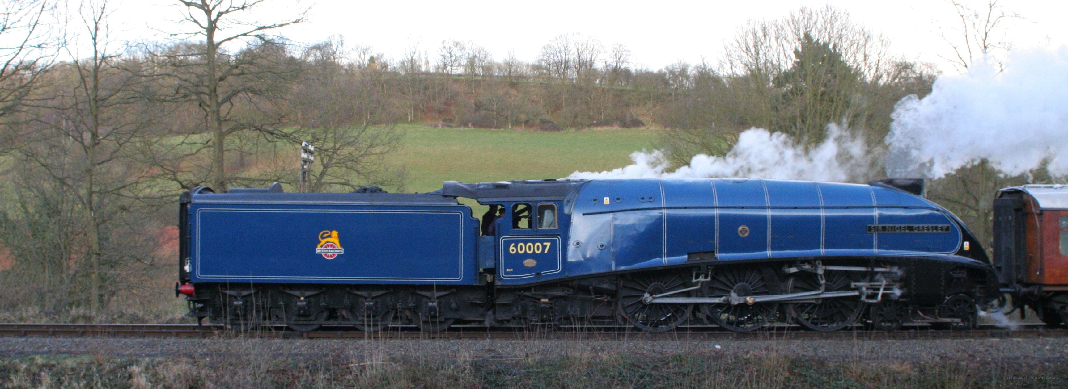 Blue steam locomotive in motion