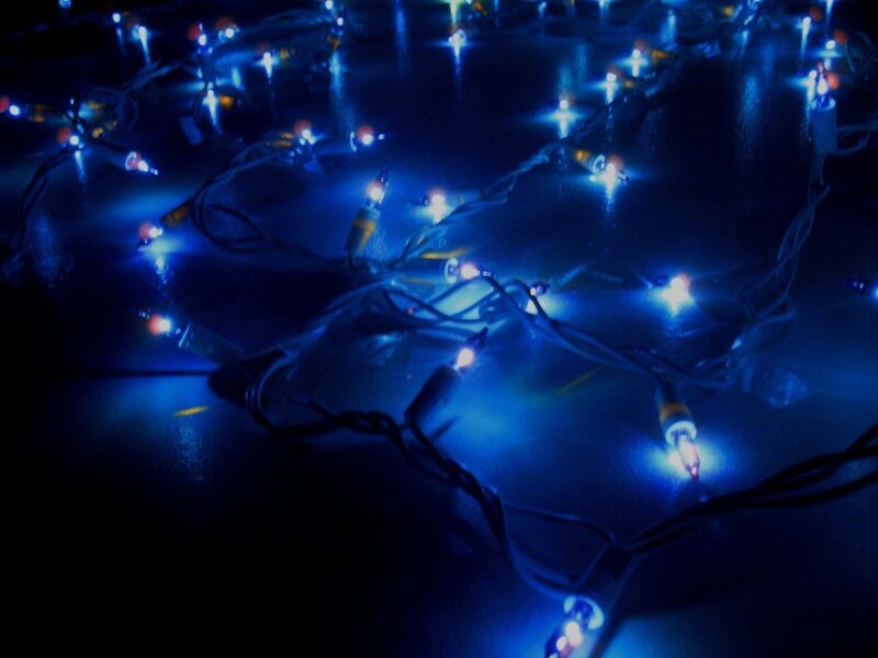 blue string lights on dark surface