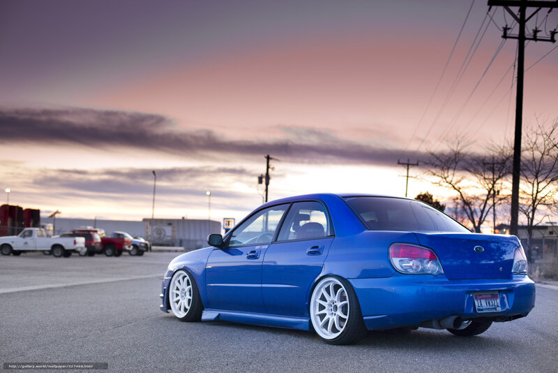 Blue Subaru at sunset