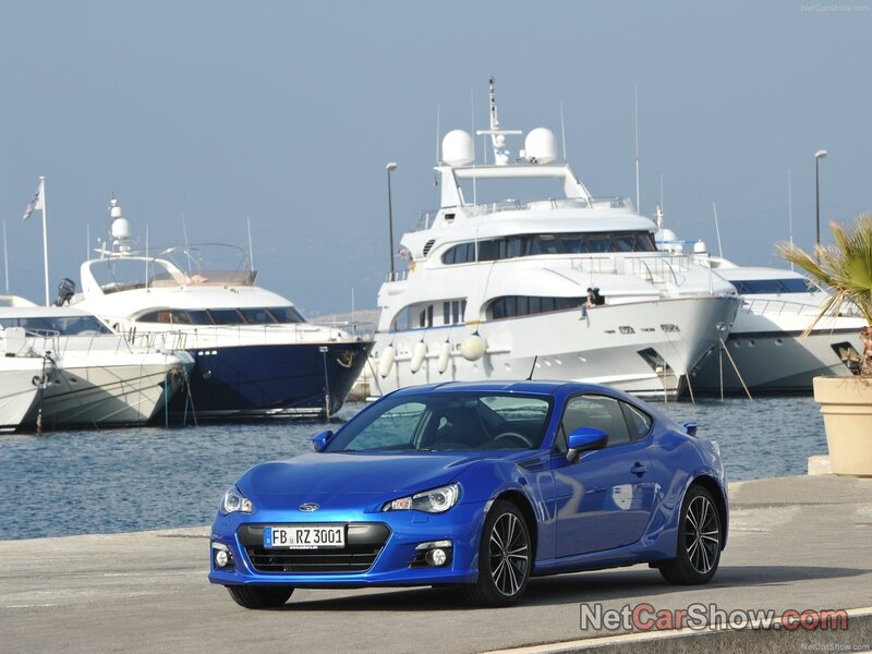 Blue Subaru BRZ at a marina