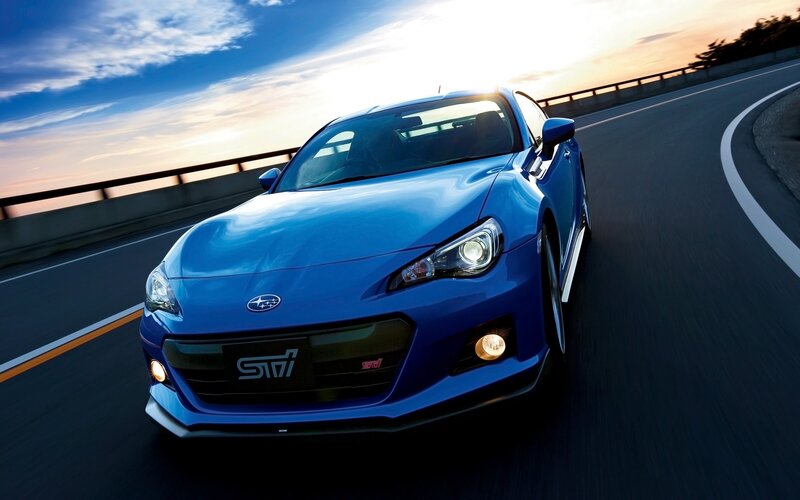 Blue Subaru BRZ on a winding road
