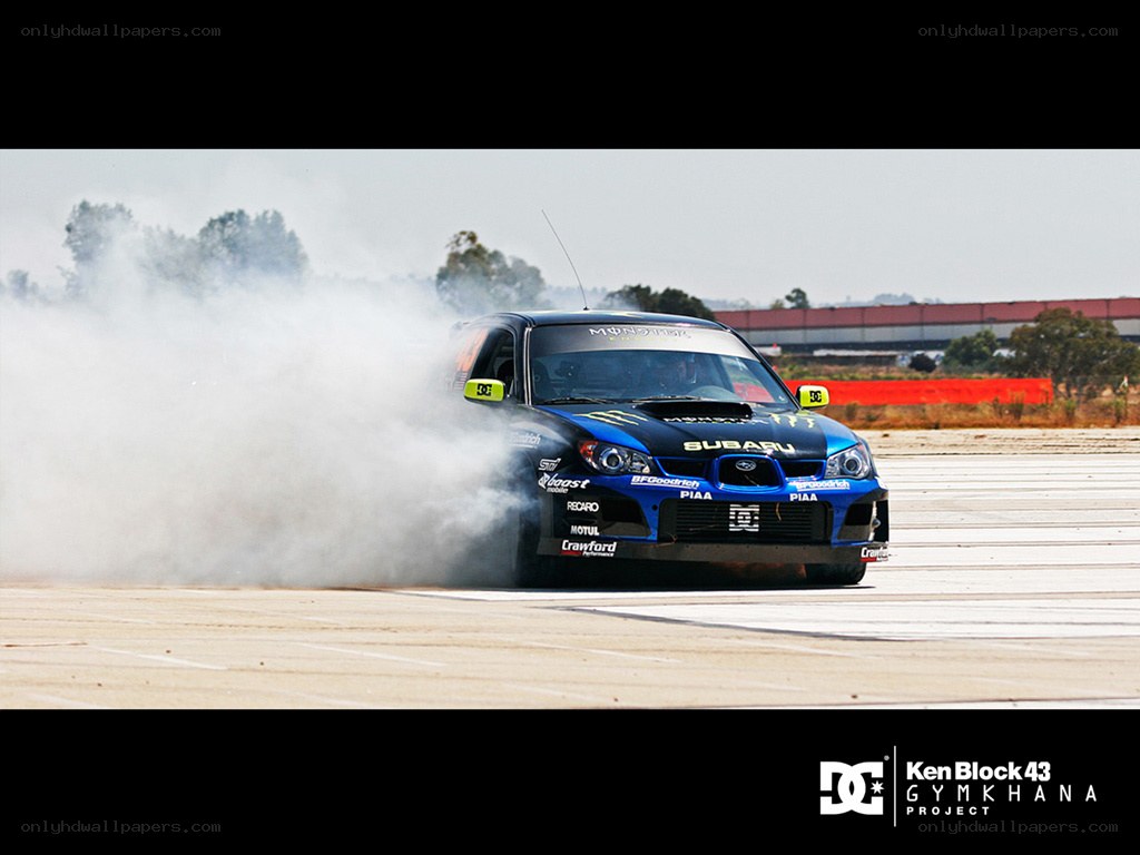 Blue Subaru drifting on track