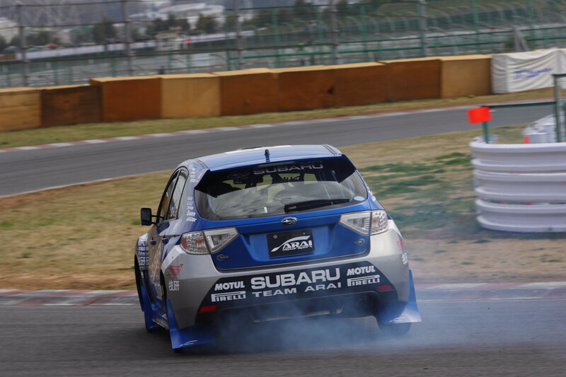 blue subaru drifting on track