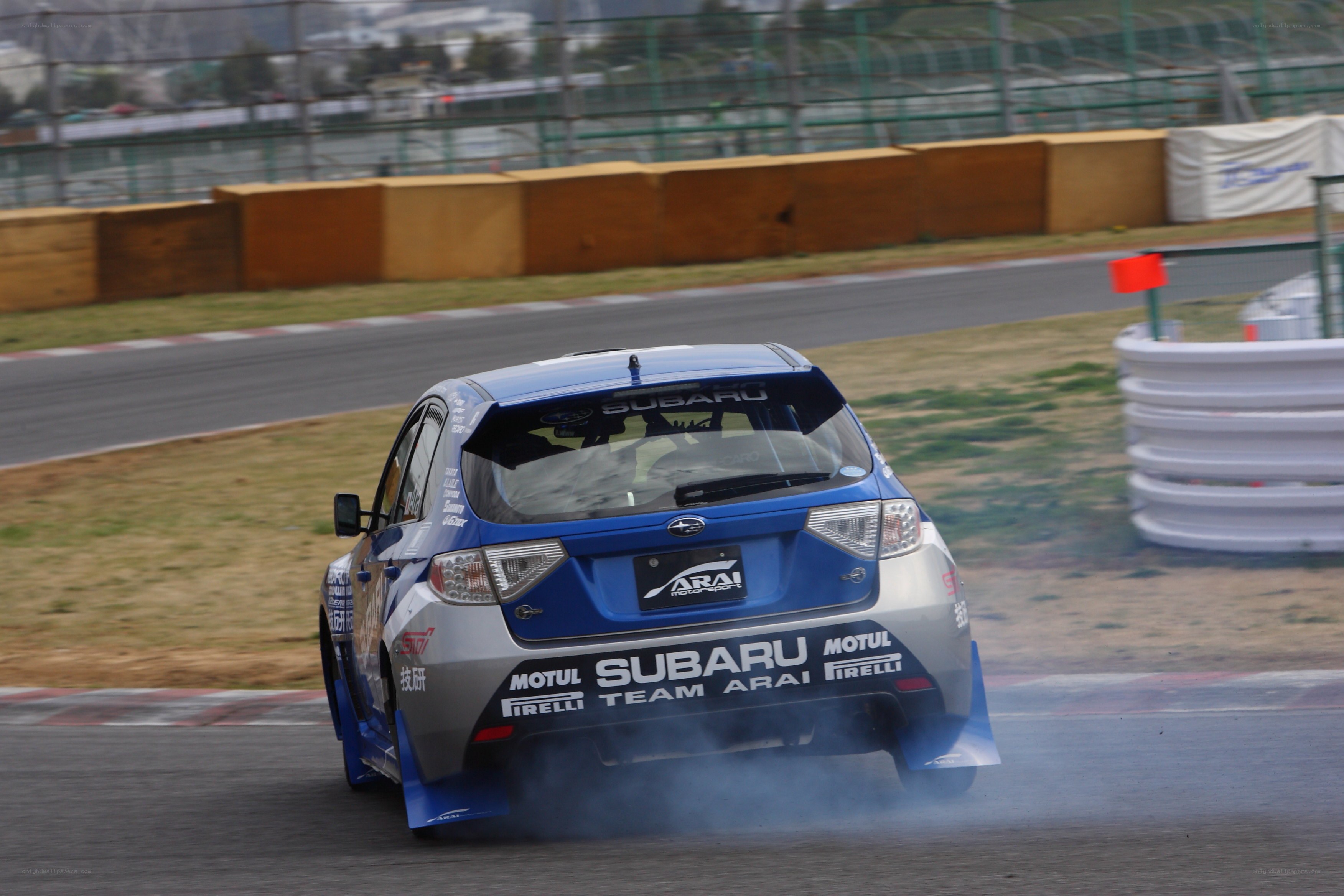 blue subaru drifting on track