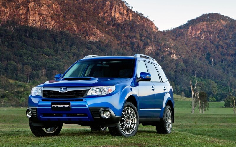 Blue Subaru Forester in a field