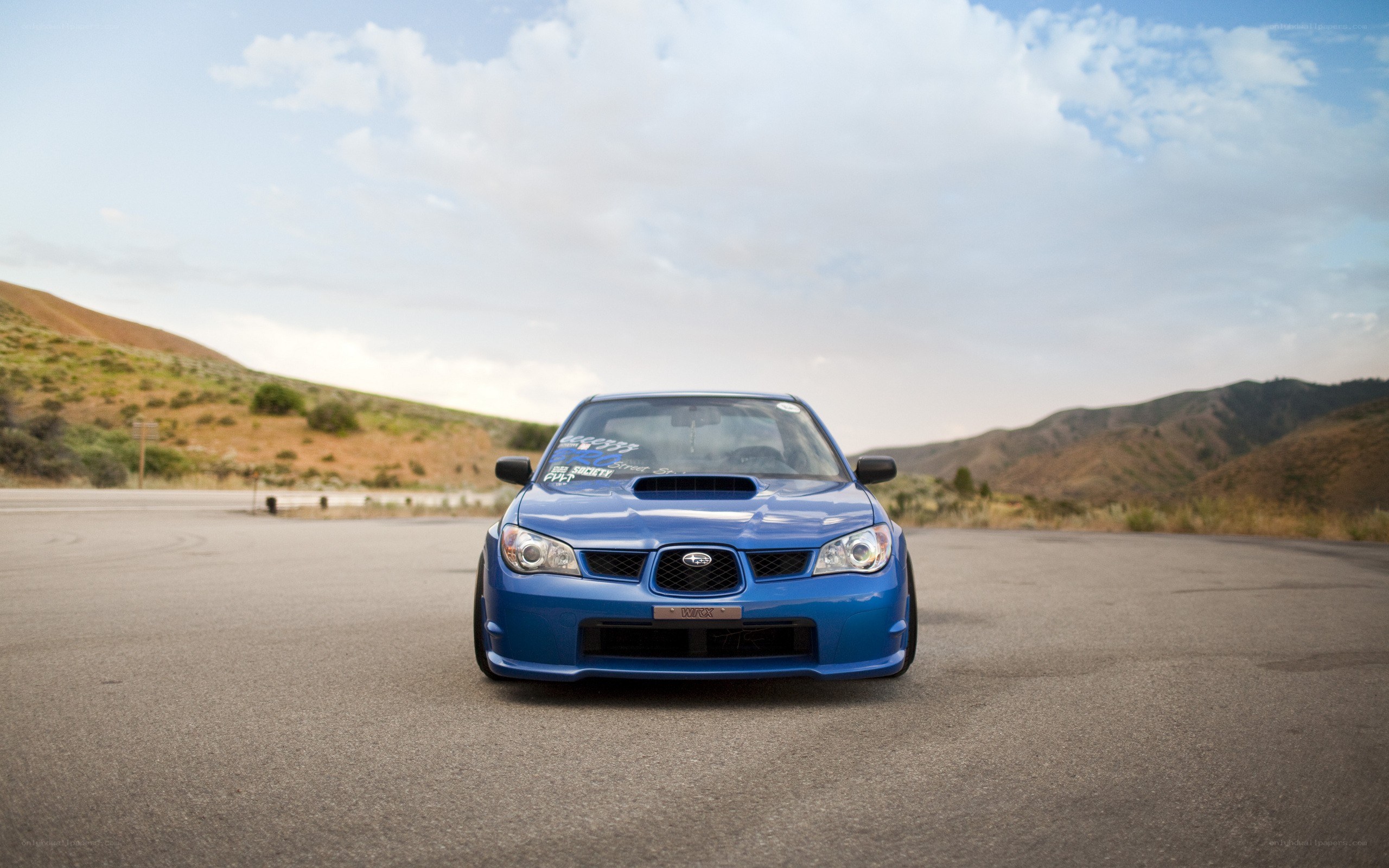 blue subaru in desert landscape