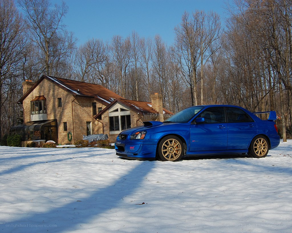 blue subaru in snow