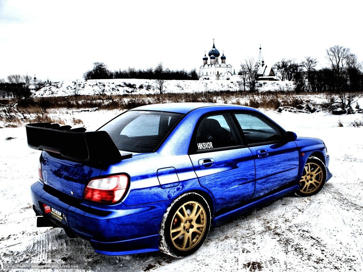 Blue Subaru in snowy landscape