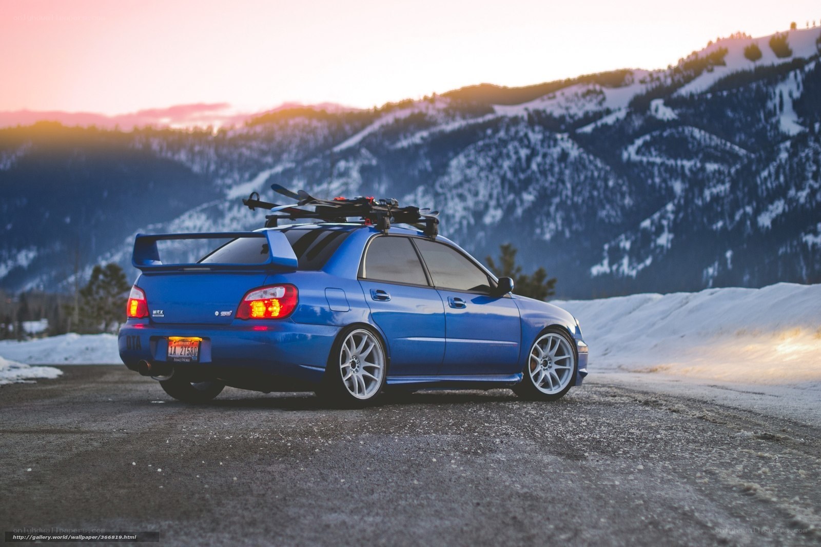 blue subaru in snowy mountains