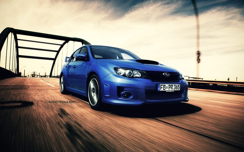 blue subaru on a bridge