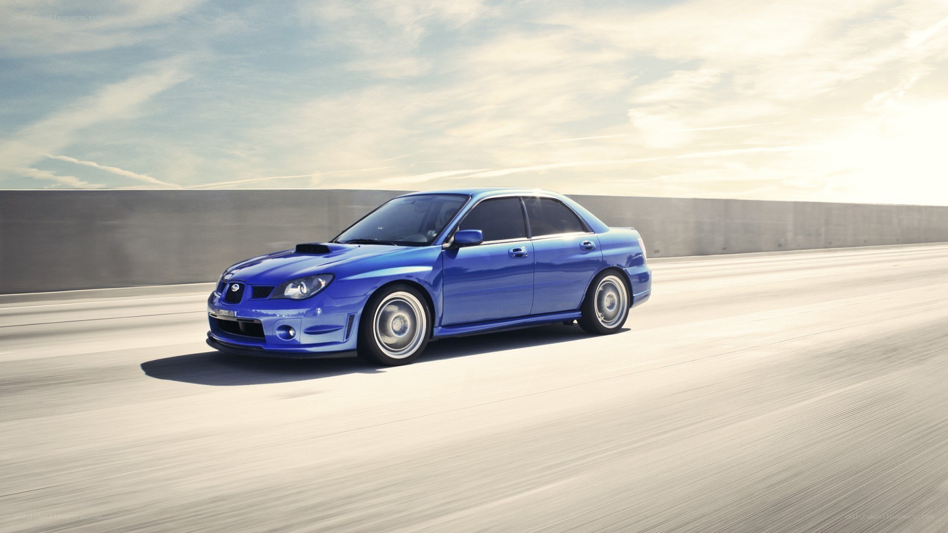 blue subaru on a highway