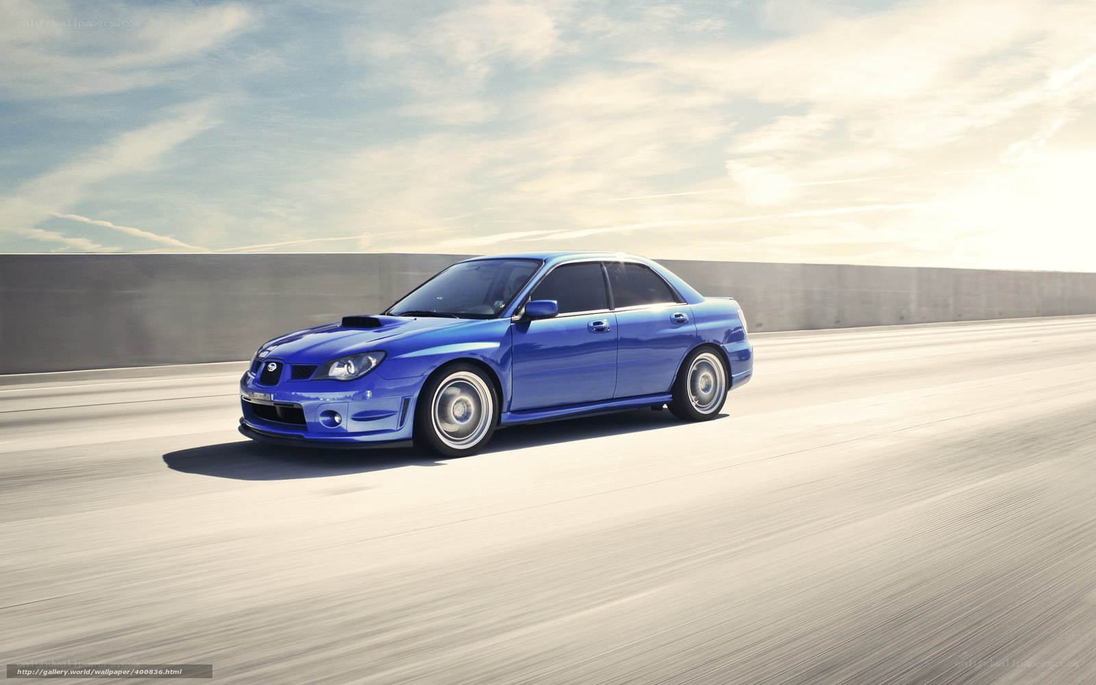blue subaru on a highway