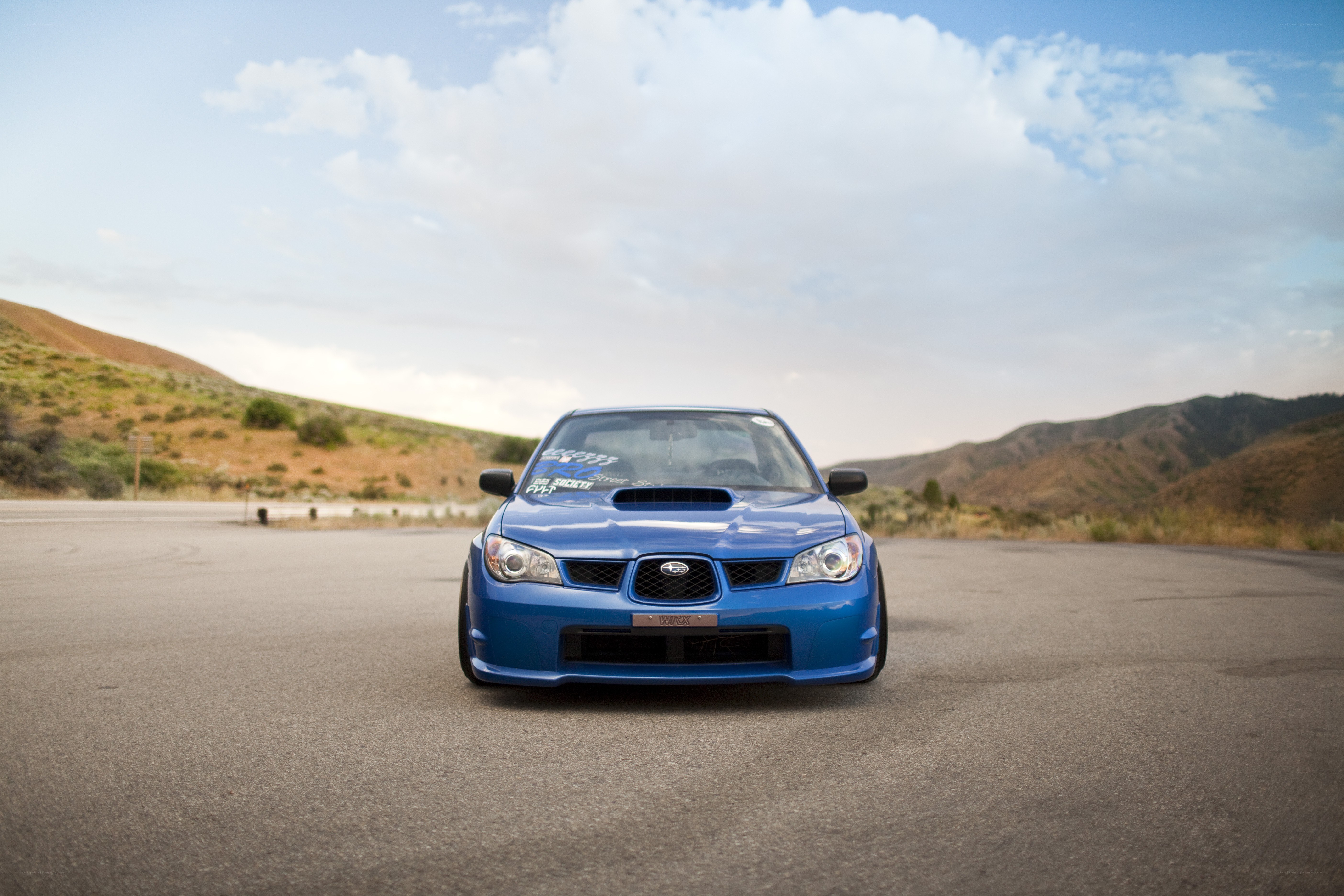 blue subaru on a road