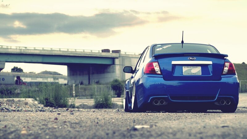 blue subaru on gravel