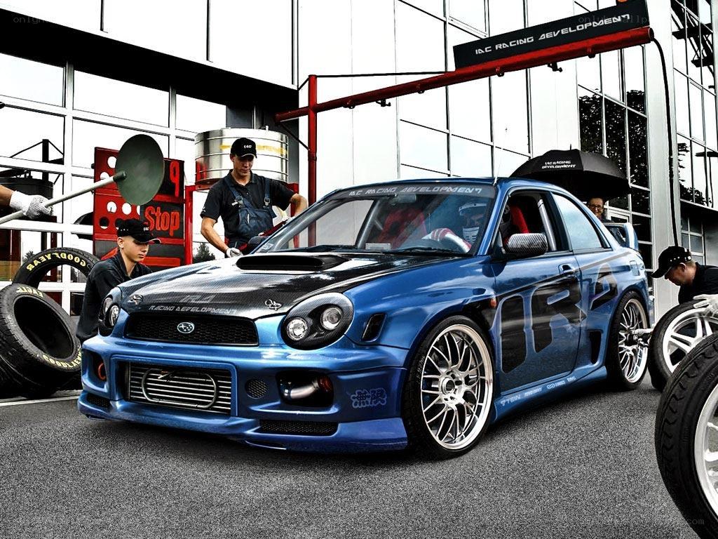 Blue Subaru race car at pit stop