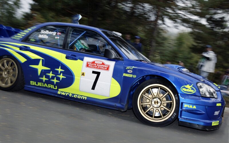 Blue Subaru rally car in action