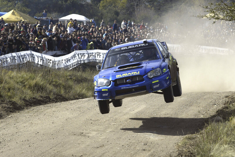 Blue Subaru rally car in action