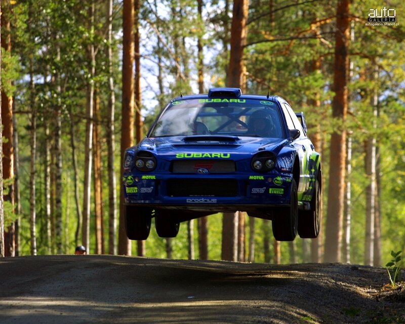 Blue Subaru rally car in mid-air
