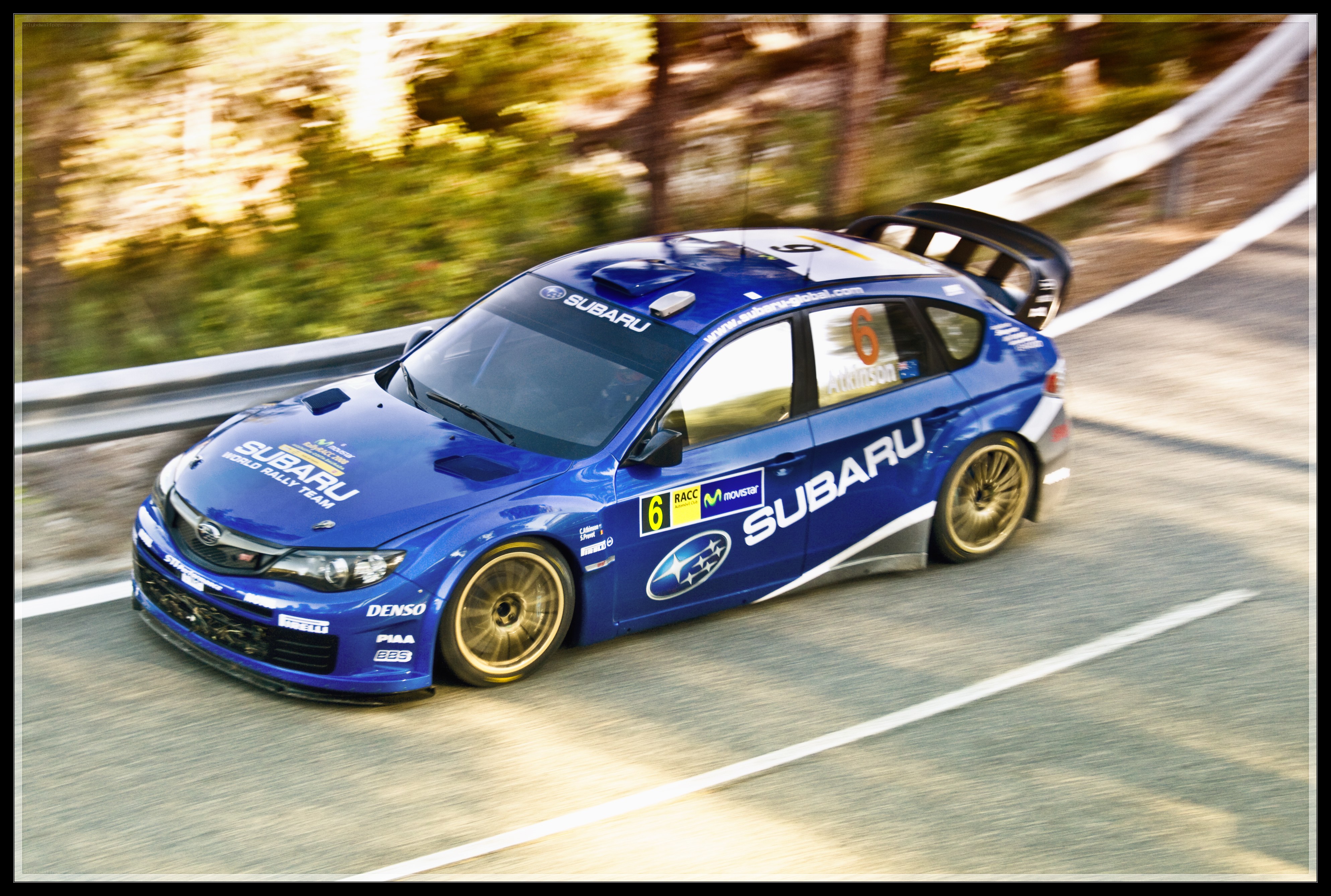Blue Subaru rally car in motion