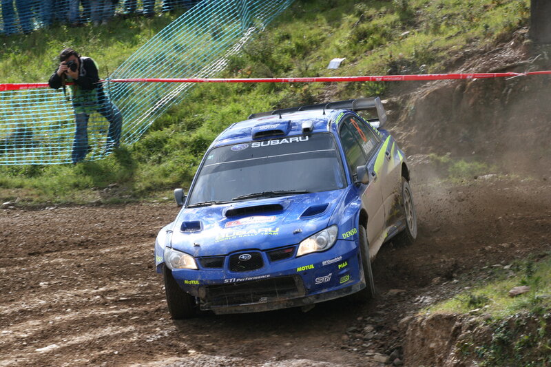 Blue Subaru rally car on dirt track