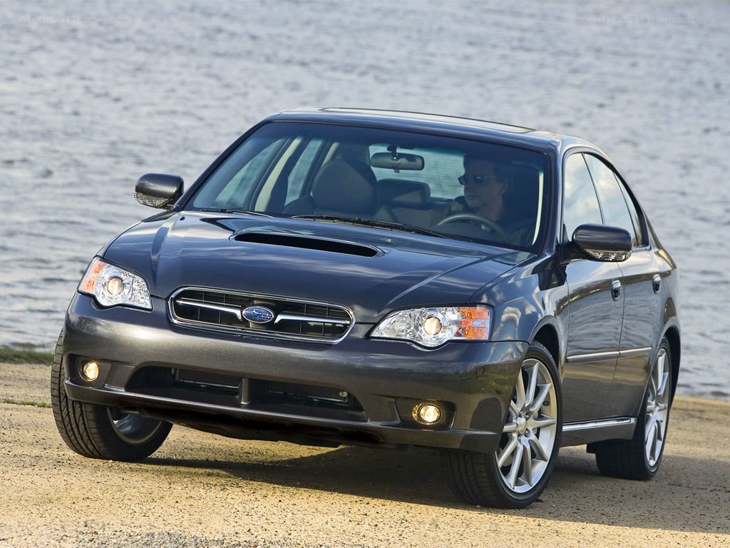 Blue Subaru sedan by water