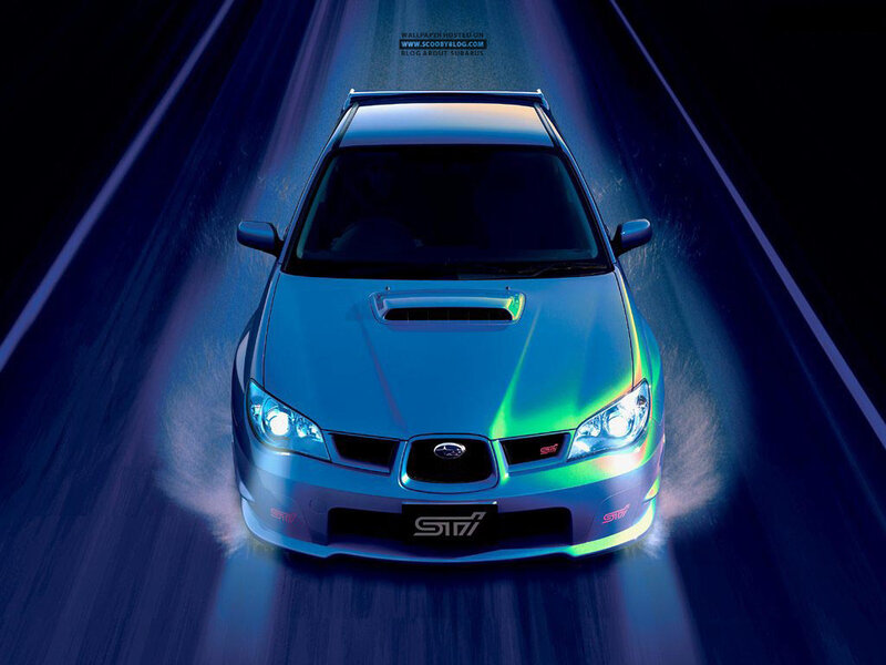 Blue Subaru STI on a dark road