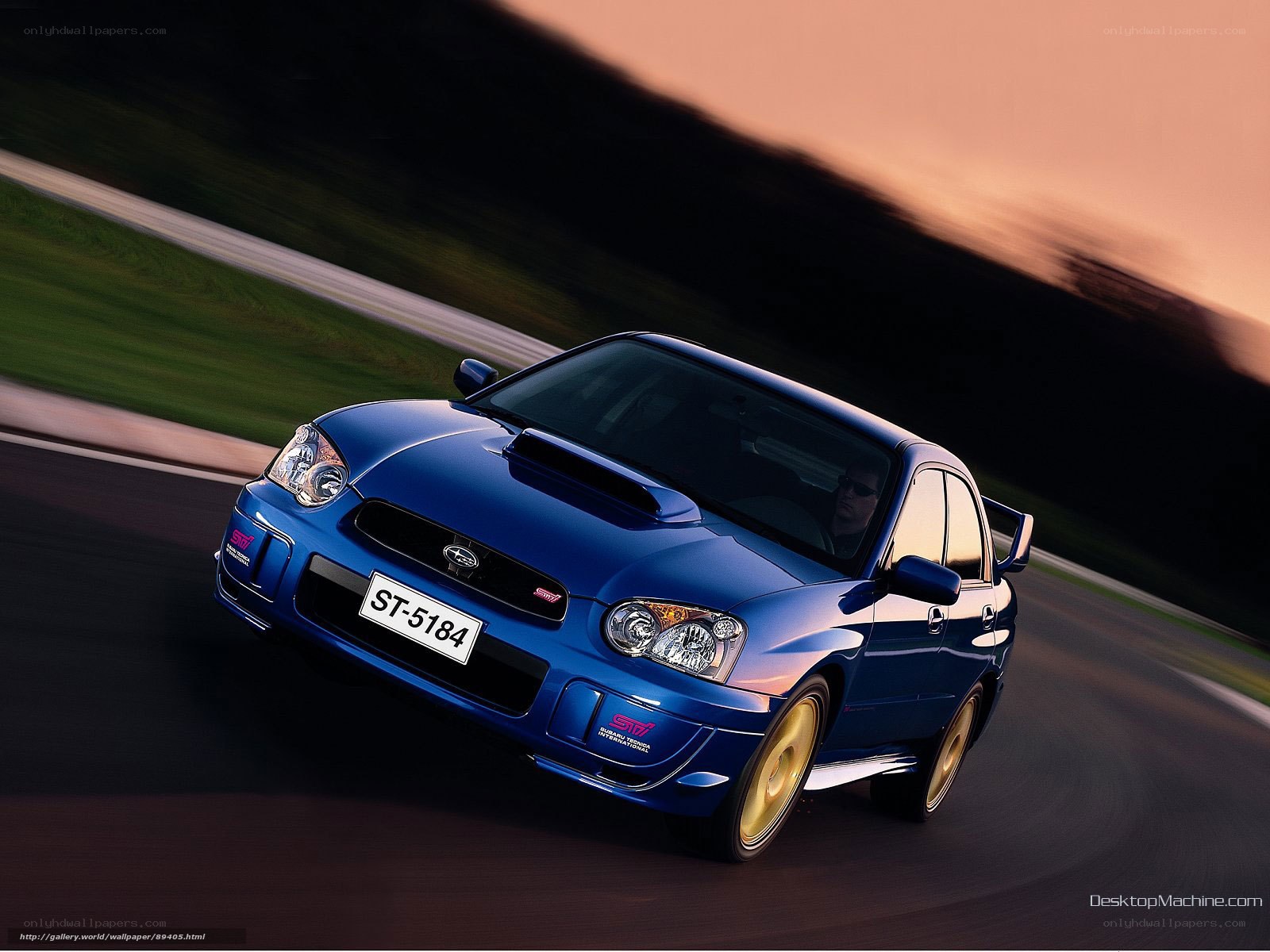 Blue Subaru STI on a racetrack