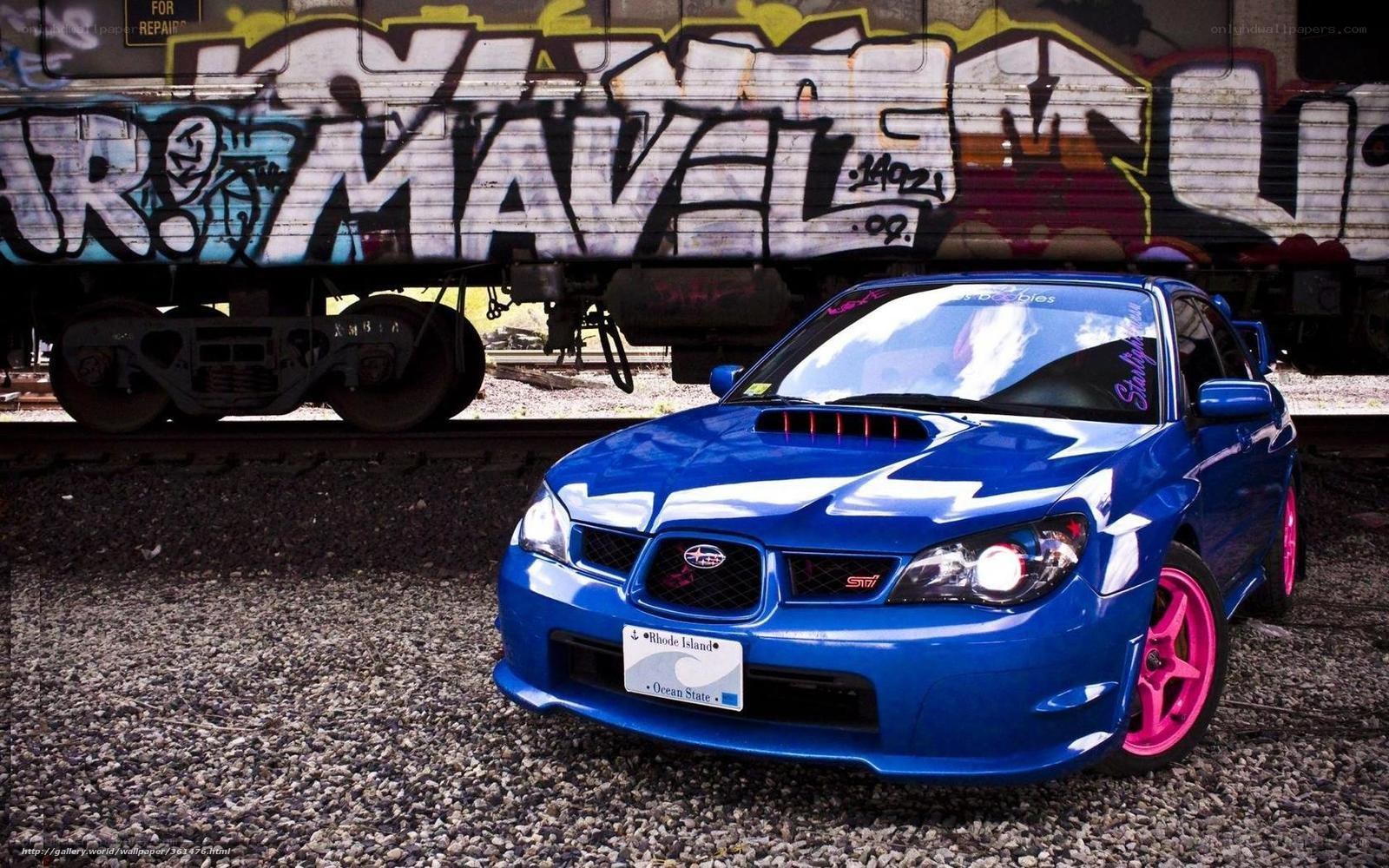 blue subaru sti on train tracks