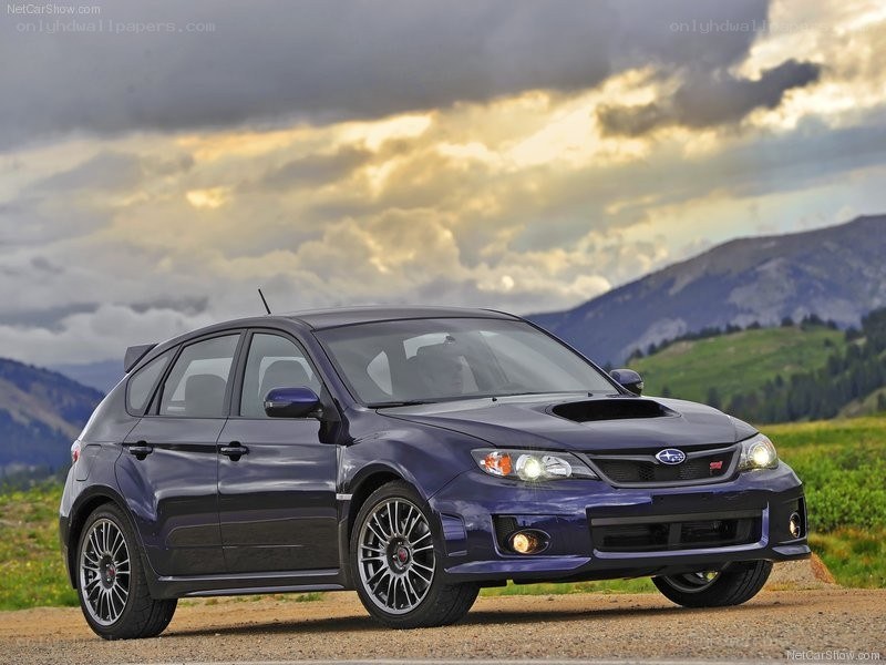 Blue Subaru WRX parked in mountains