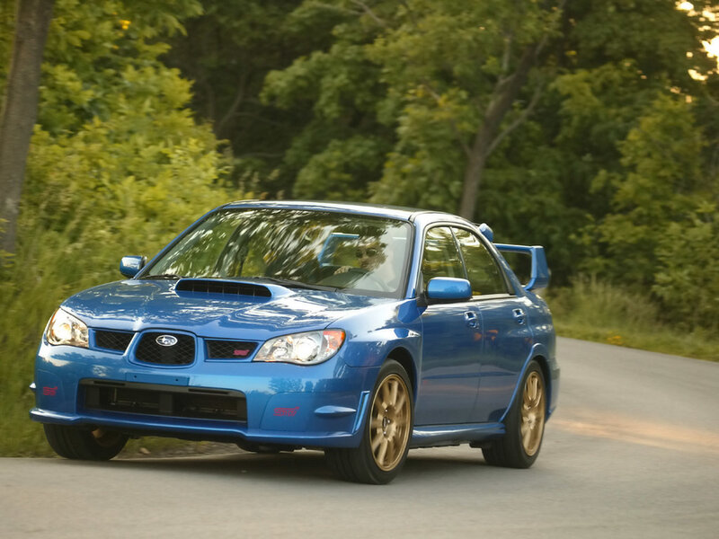 blue subaru wrx sti on road