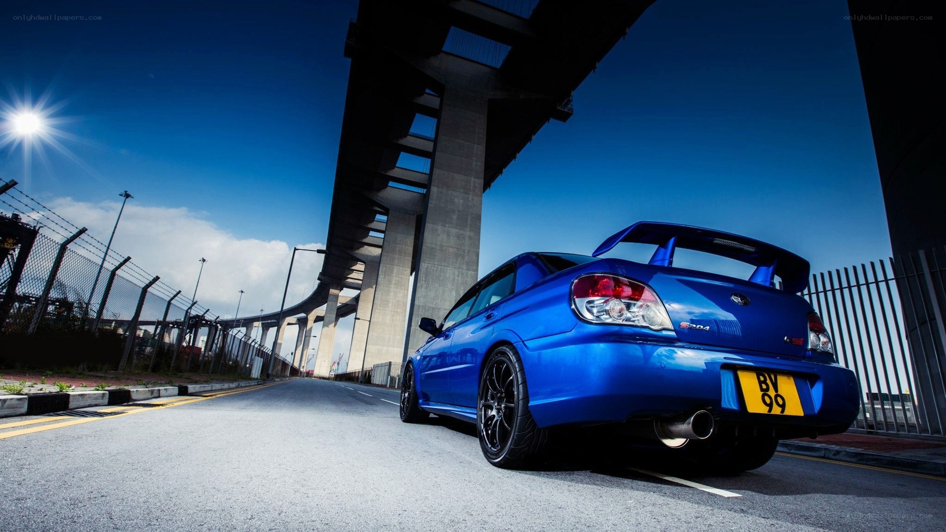 blue subaru wrx sti under bridge